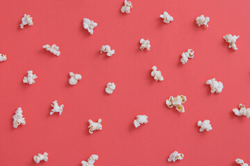 White popcorn on pink background, popcorn texture