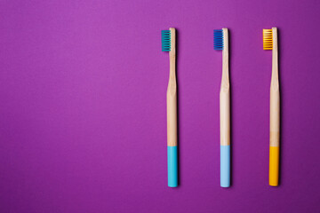 bright toothbrushes on a Violet background