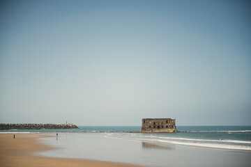 Casa Del Mar. The Atlantic ocean, the Cape Juby, Morocco. The ruined fortress, a tide, sand beach, birds.