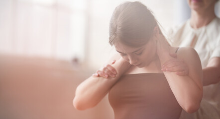 Young beautiful girl has Thai massage at spa salon with professional masseur. Morning tranquil mood. Copy space