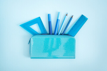 Blue stationery, school supplies on a blue background. Concept for back to school, education. Perfectionism, order in the workplace. Mockup, copy space.
