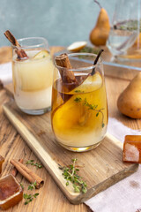 summer drink with a pear in a glass on a wooden background