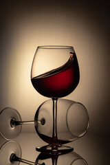 Still life, glass glasses with wine, on a background with a spot, and with a reflection