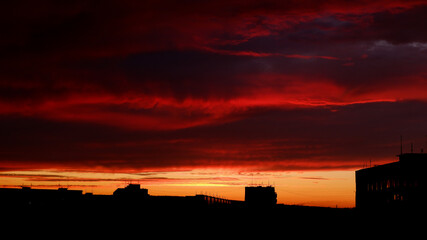 
red hellish sunset over the city rooftops