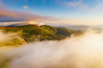Splendid view from a drone flying over the morning alpine mountains.