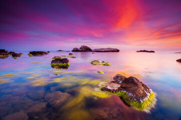 Majestic cloudscape over the sea. Vivid clouds illuminated by the beams of the sun.