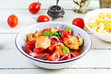 Traditional italian salad Tuscan Panzanella with tomato, bread and pickled olives