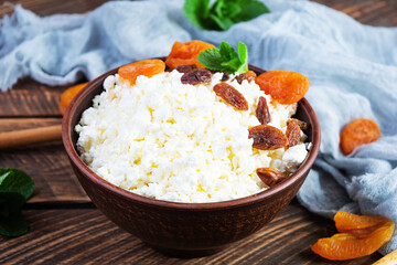 Healthy breakfast cottage cheese with raisins, dried apricots, almond, cashew and mint