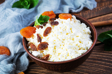 Healthy breakfast cottage cheese with raisins, dried apricots, almond, cashew and mint