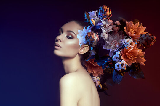 Beauty flowers face of a woman with double exposure. Portrait of a girl neon light and color, professional makeup, nude back of a woman, flowers in the head