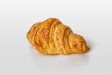 Croissant with a golden crust, prepared in a French bakery, on a white background