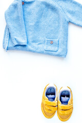 Baby clothes and toys on white background top view mock up