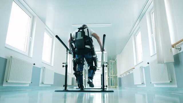 Male patient is practicing walking in the exoskeleton