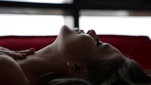 excited sexy lady in bed during sex or preliminary caress, closeup portrait shot