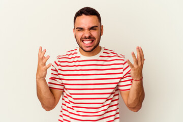 Young caucasian man isolated on white background screaming with rage.