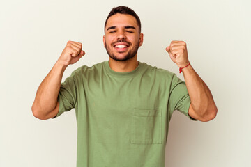Fototapeta premium Young caucasian man isolated on white background celebrating a victory, passion and enthusiasm, happy expression.