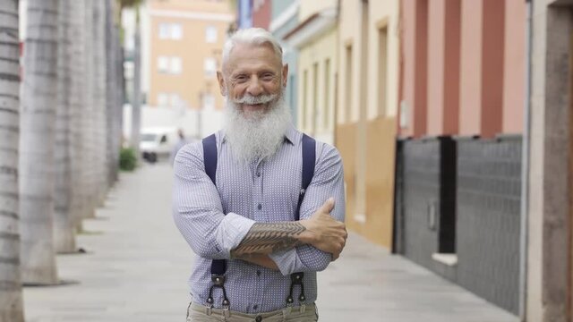 Business hipster senior man looking at camera with city on background