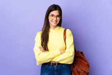 Teenager Brazilian student girl over isolated purple background laughing