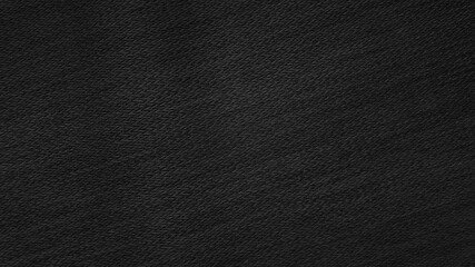 photography of black woolen fabric texture background. dark black clothing background. black texture with blank space for design.