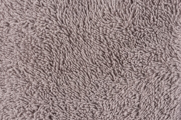 Closeup of a brown towel. Textile details backdrop