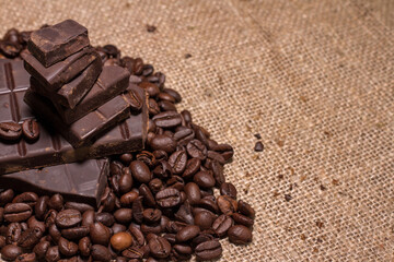Broken slices of chocolate and coffee beans.