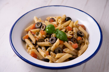 Sicilian pasta with tomato and black olives.