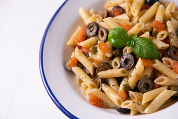 Sicilian pasta with tomato and black olives.