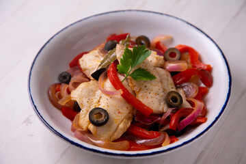 Grilled white fish with red peppers and onion. Traditional tapa from southern Spain.