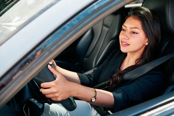 Fototapeta na wymiar young latin woman driving luxury car