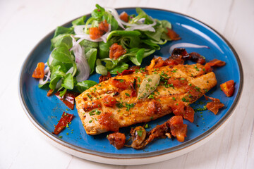 Grilled palometa fish with chili and onion. Traditional tapa from southern Spain.