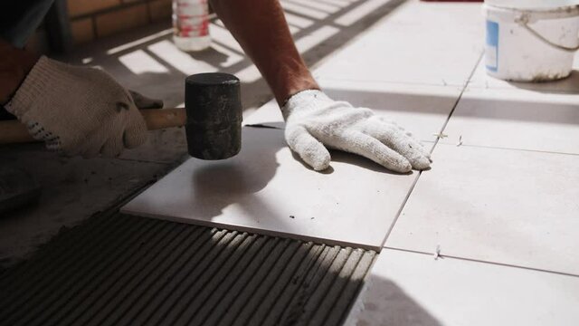 footage of laying ceramic tiles