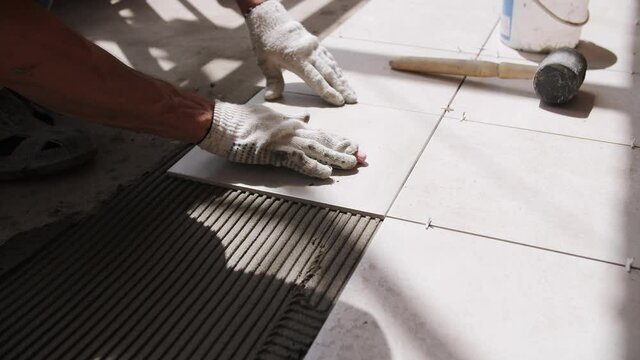 footage of laying ceramic tiles