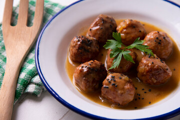 Tapa of meatballs with homemade sauce in a Spanish restaurant.