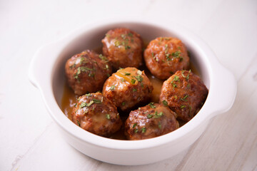 Tapa of meatballs with homemade sauce in a Spanish restaurant.