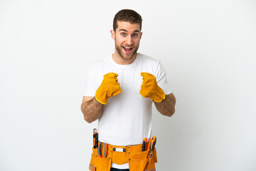 Young electrician man over isolated white wall celebrating a victory in winner position