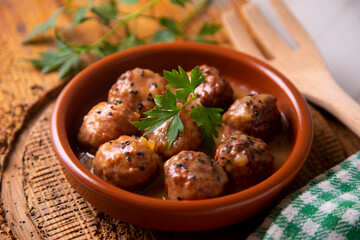 Tapa of meatballs with homemade sauce in a Spanish restaurant.