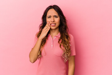 Young mexican woman isolated on pink background having a strong teeth pain, molar ache.