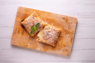 Puff pastry with custard and rolled almonds. Traditional Spanish cuisine dessert.