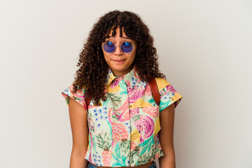 Young mixed race woman wearing sunglasses taking a vacation isolated confused, feels doubtful and unsure.