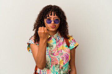 Young mixed race woman wearing sunglasses taking a vacation isolated showing fist to camera, aggressive facial expression.