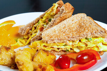 Omelet sandwich and baked potatoes 