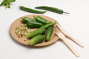 Cucumbers, Sprouted mung bean sprouts and green peppers on cardboard disposable plate