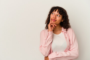 Young mixed race woman isolated on white background looking sideways with doubtful and skeptical expression.