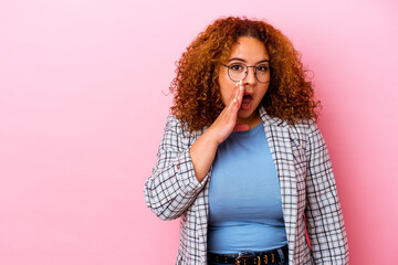 Young latin curvy woman isolated on pink background is saying a secret hot braking news and looking...