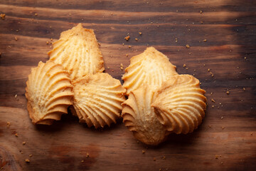 Close-up of delicious freshly baked simple cookies or biscuits. Isolated over a wooden top  background.