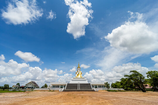 Big Buddha statues on a sunny day with clear blue sky, Sisaket Province, Thailand.