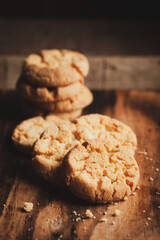 Close-up of delicious freshly baked simple cookies or biscuits. Isolated over a wooden top  background.
