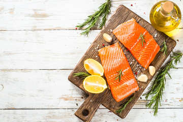 Salmon, fresh salmon fillet at cutting board with ingredients for cooking. Top view with copy space. - obrazy, fototapety, plakaty