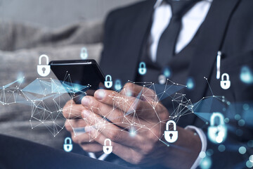 A programmer is browsing the Internet in smart phone to protect a cyber security from hacker attacks and save clients confidential data. Padlock Hologram icons over the typing hands. Formal wear.