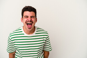 Obraz premium Young caucasian man isolated on white background shouting very angry, rage concept, frustrated.